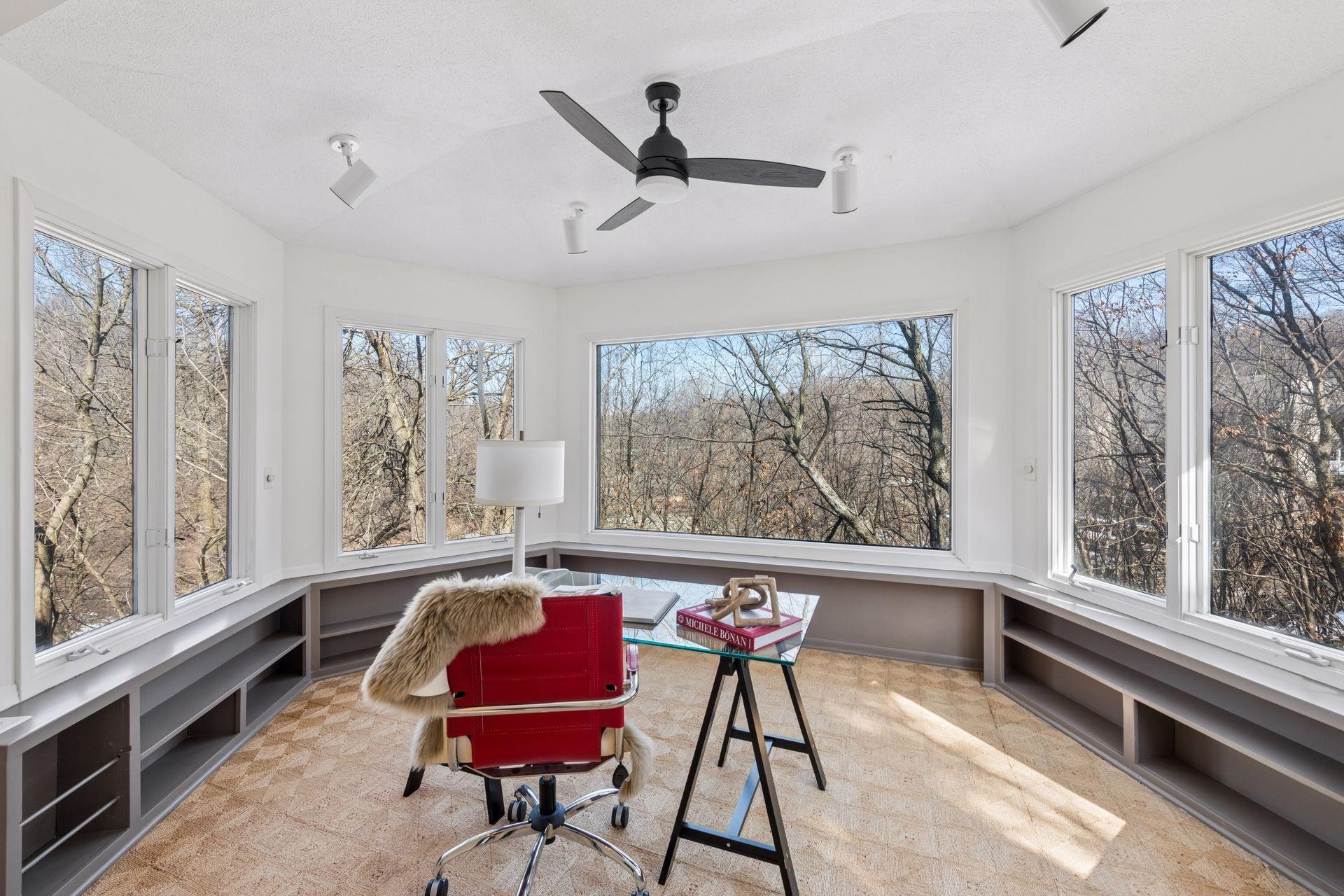 Three-season porch, with panoramic views of the backyard pond.