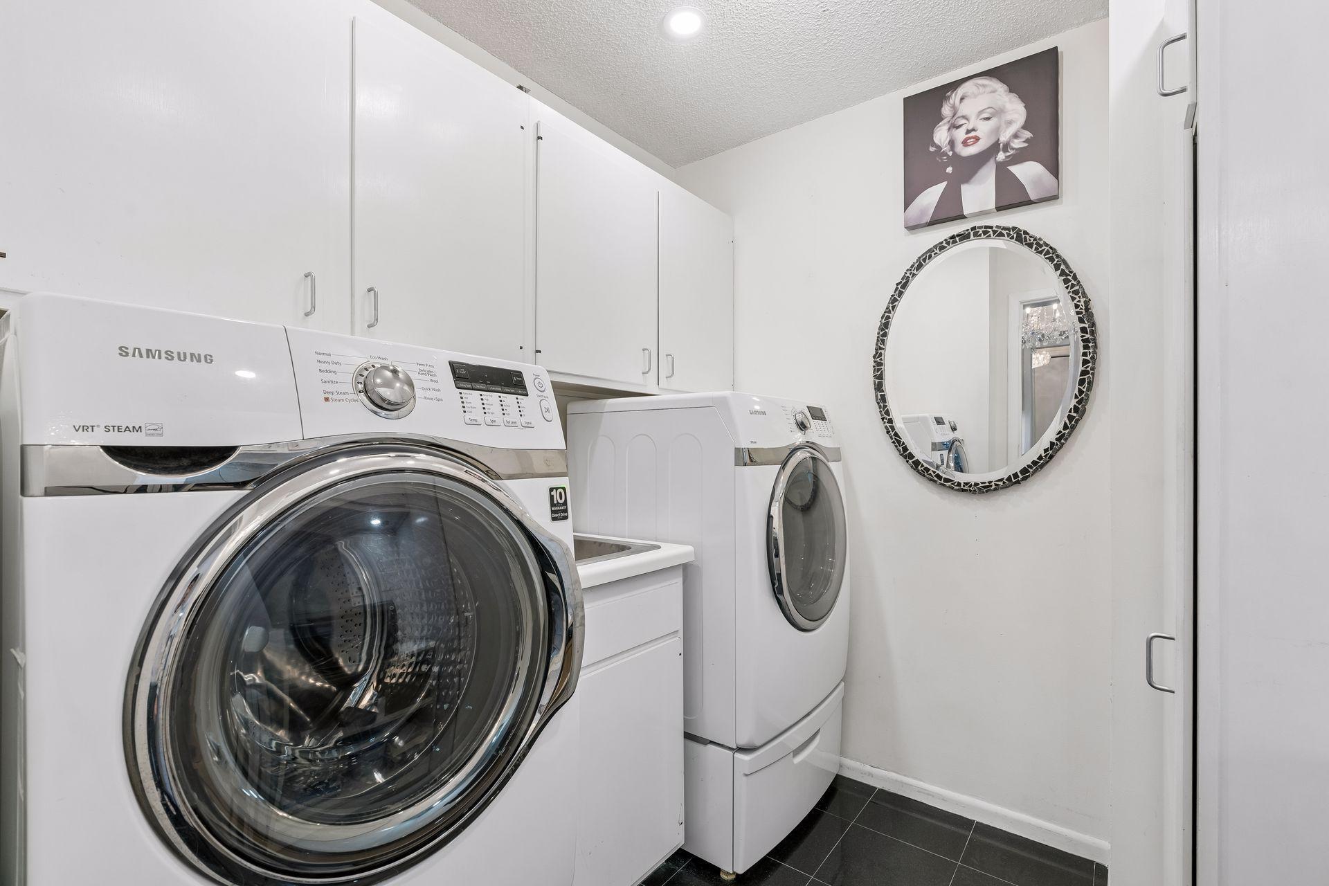 Just off the kitchen is the large laundry room with full size washer & dryer & extra storage cabinets.