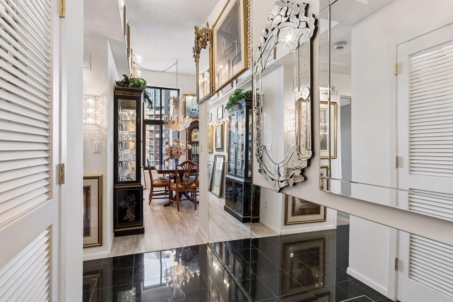 Looking down the hallway from the front door natural light from the dining room window reaches all the way to the entrance.