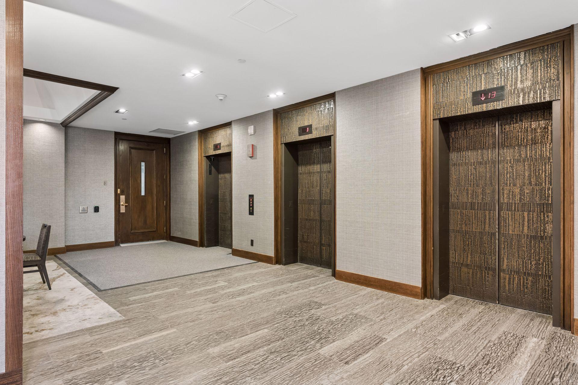 Take one of these three elevators up to the top floor(17). Also the door to the left of the elevators takes you to your parking spot.