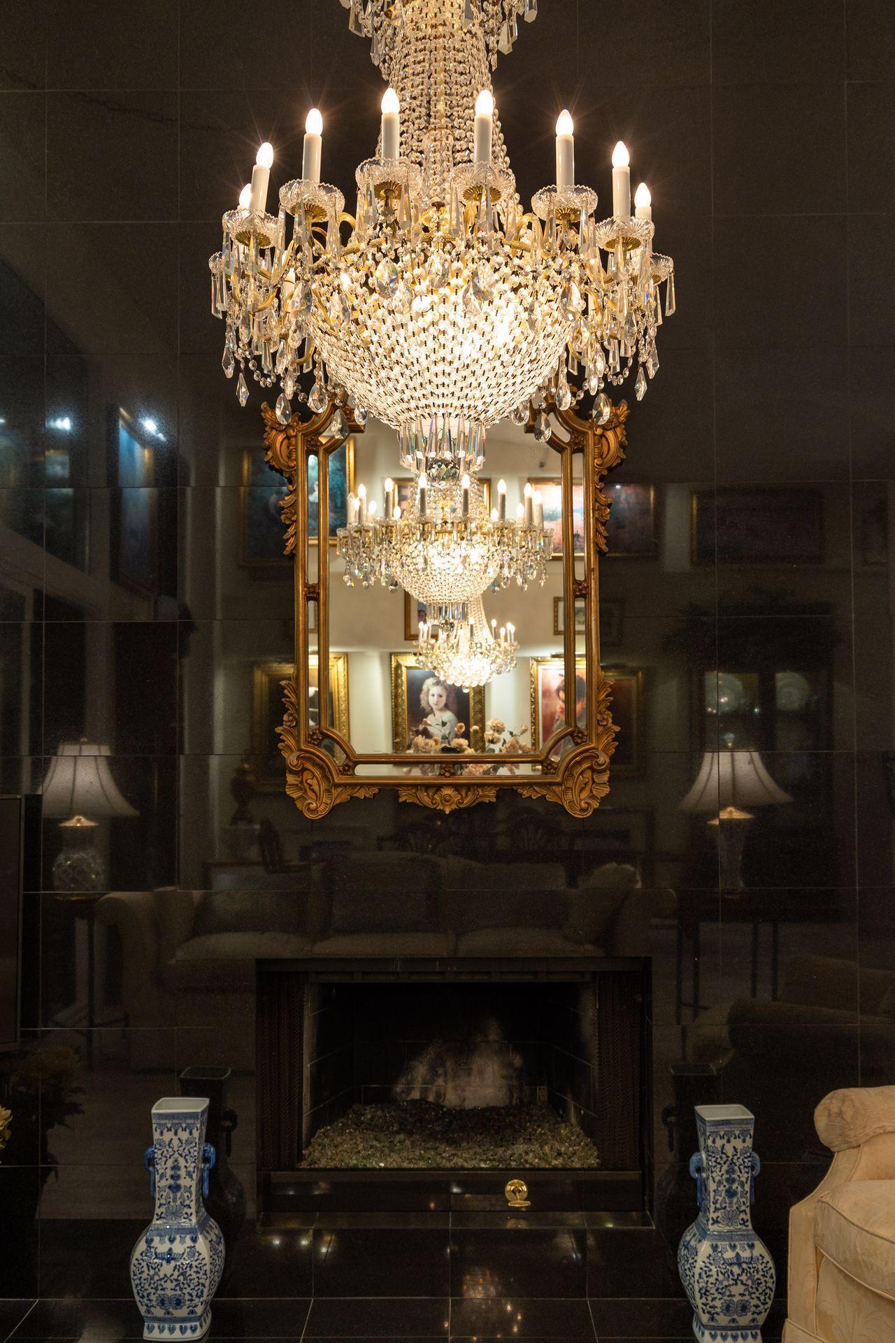 Regal reflections of the living room & dining room chandeliers at night