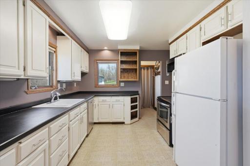 This mudroom and kitchen greet you as you enter this classic farmhouse