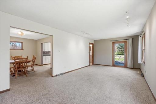 A spacious living room with exits to the deck