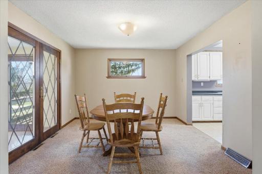Large dining room off of kitchen with beautiful french doors to the bright and enclosed porch