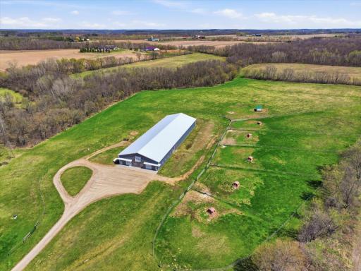 Trailer parking galore with multiple large pastures surround this large, beautiful equestrian stable