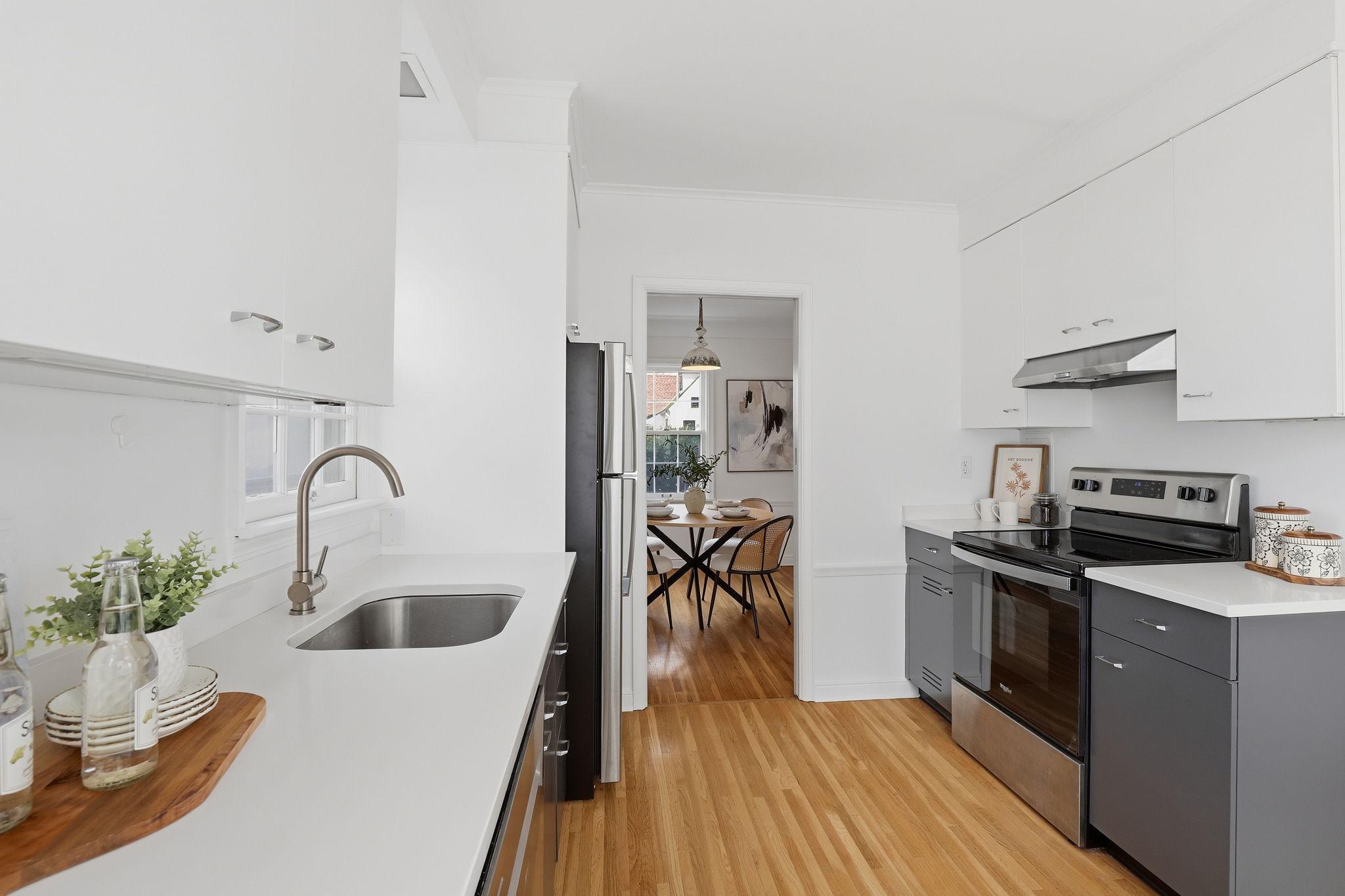 Freshly painted kitchen with stone tops and hardwood floors