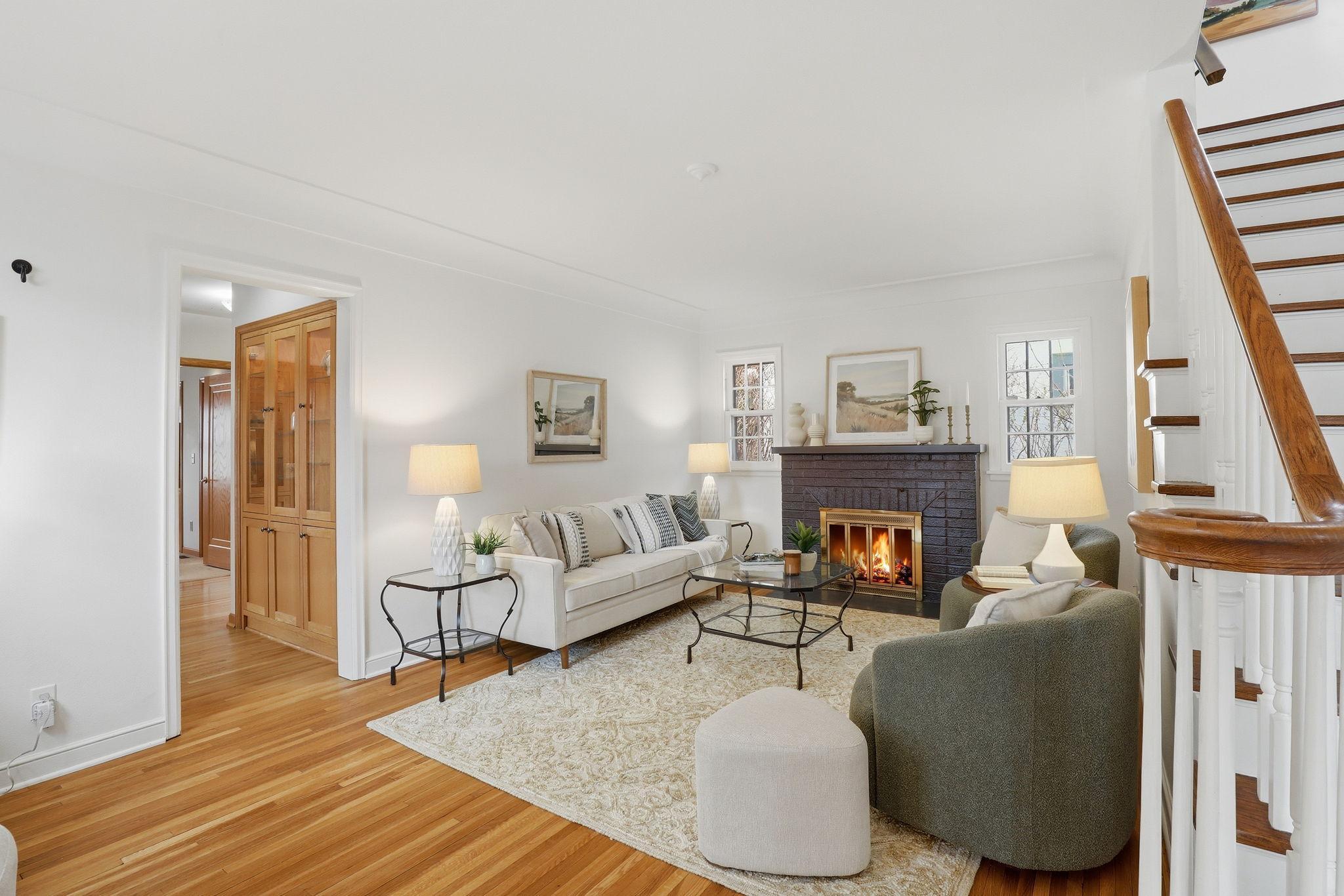 Main floor living room with fa cozy fireplace