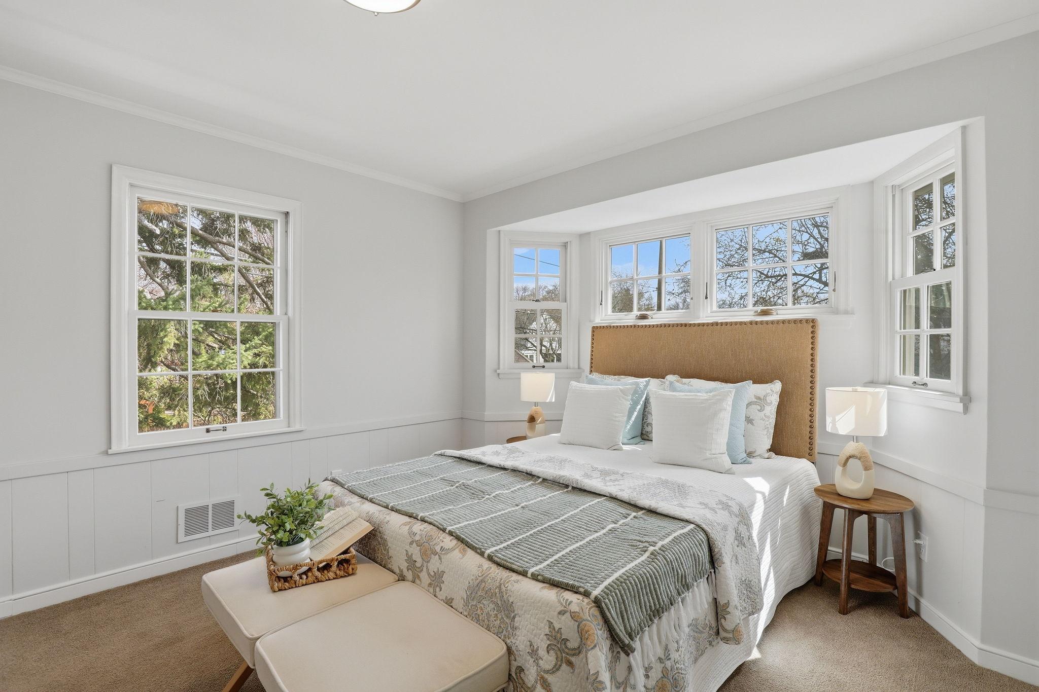 Upper bedroom surrounded by windows