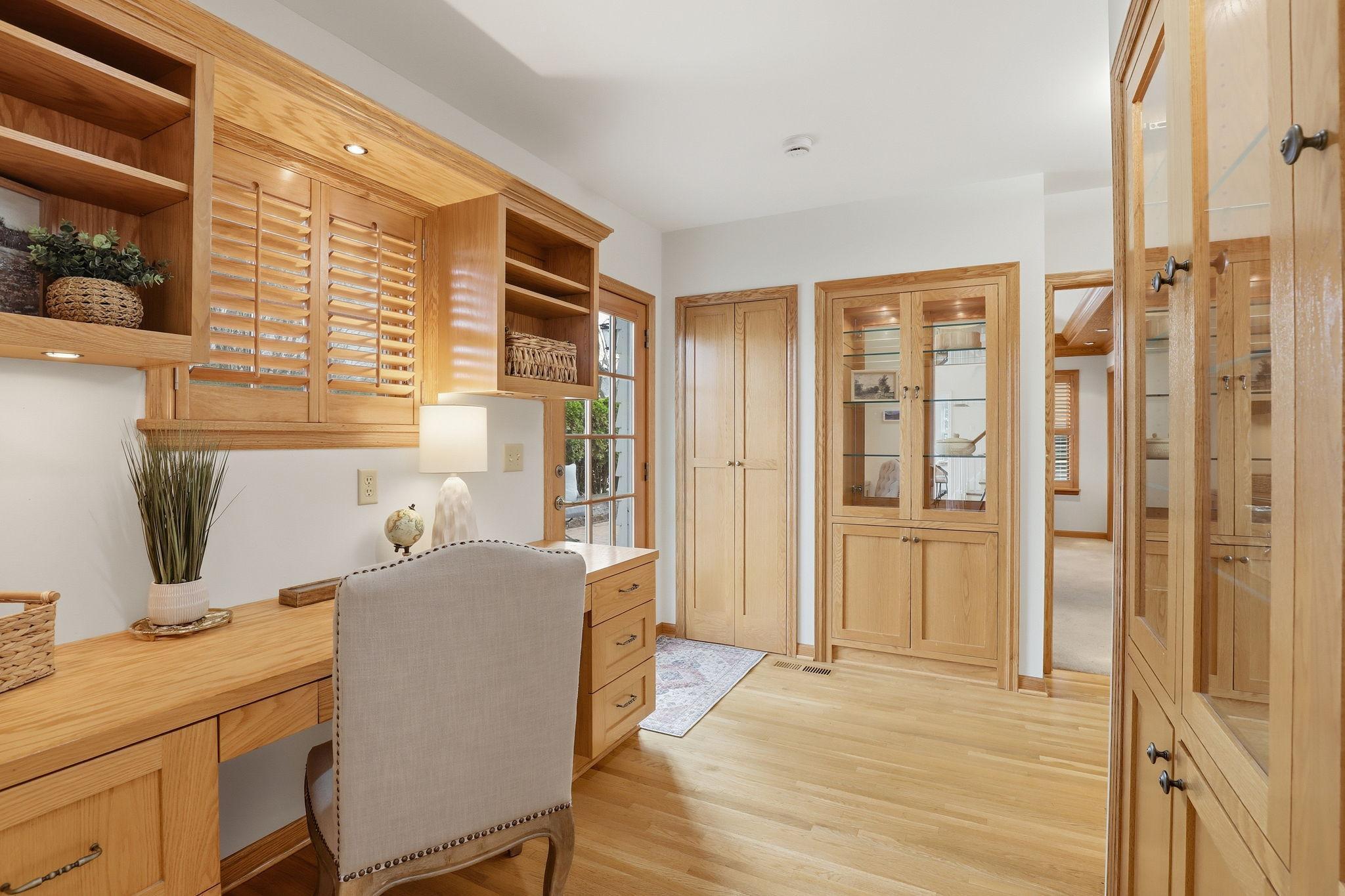 Main floor office with built-in desk and cabinets