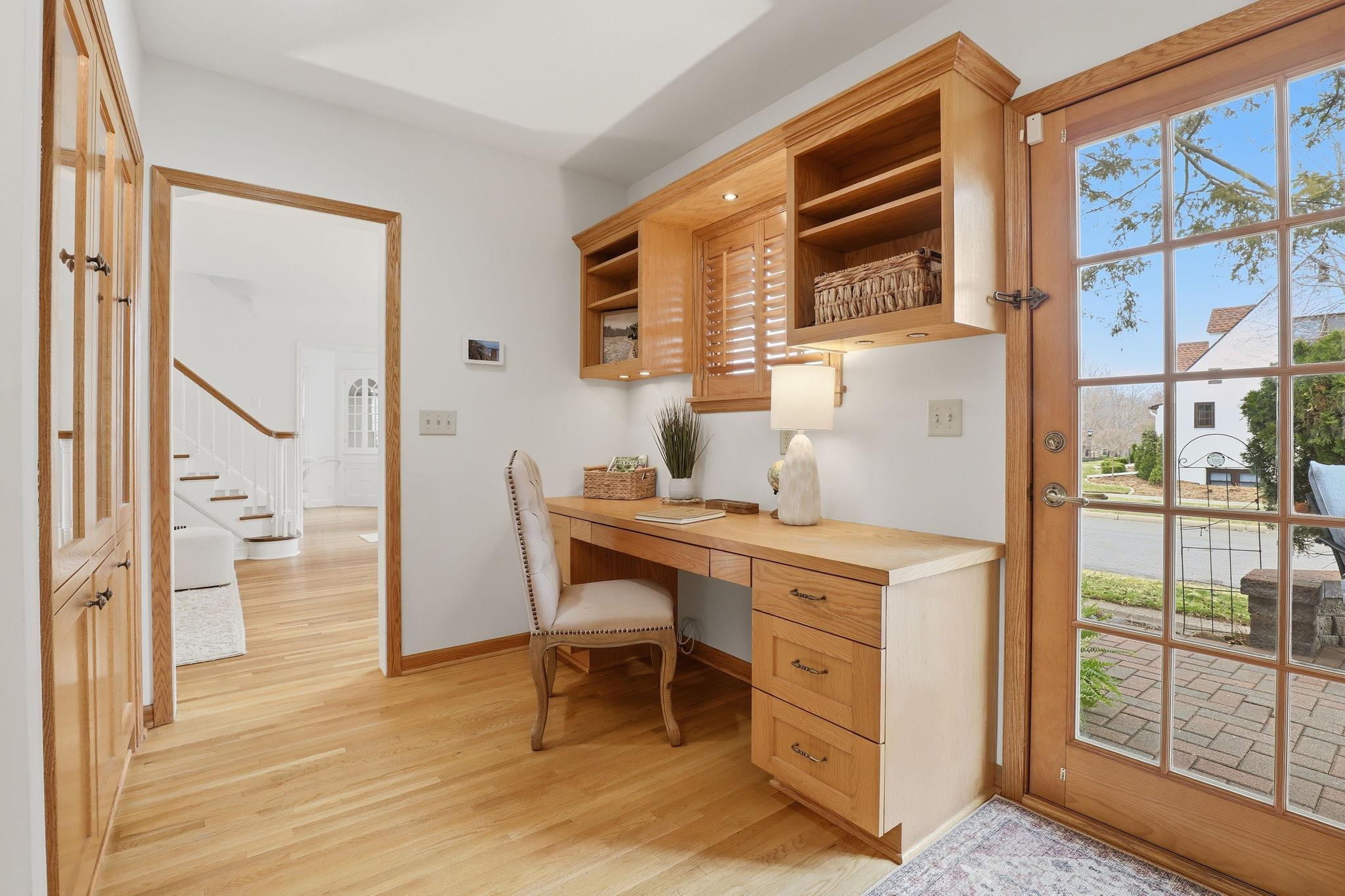 Main floor office with built-in desk and cabinets