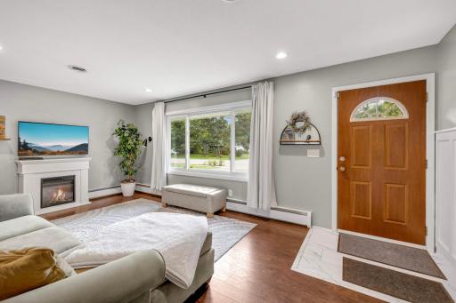 Everything in this living room has been upgraded by the current owners from the new flooring to fresh paint on the walls, new Renewal by Andersen window and new recessed lighting.