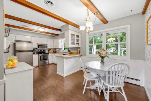 The beams in this kitchen and dining space really make the space so charming.