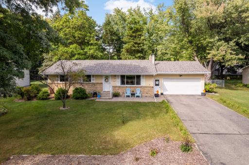 A welcoming front patio, a boulevard filled to the brim with phlox (a beautiful and abundant perennial) and more perennials across the front of the yard, with the driveway lines with daylilies, and ready for you to enjoy without lifting a finger.