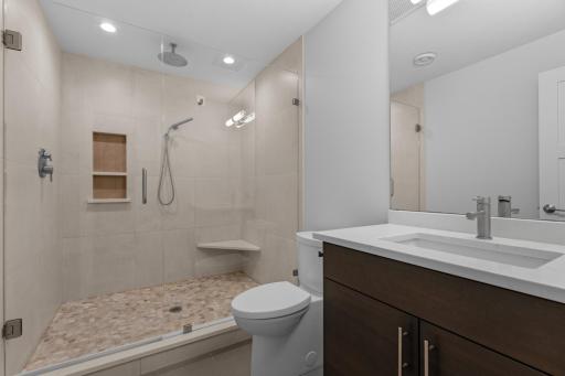 3/4 lower level bathroom with tiled shower