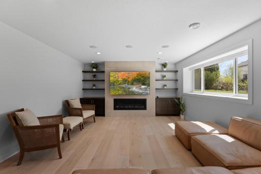 With gas fireplace, built in floating shelves/cabinets and LVP flooring.