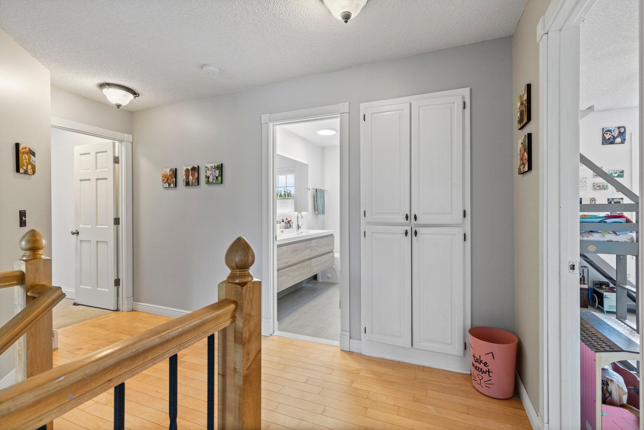 Upper level hallway/foyer with linen closets