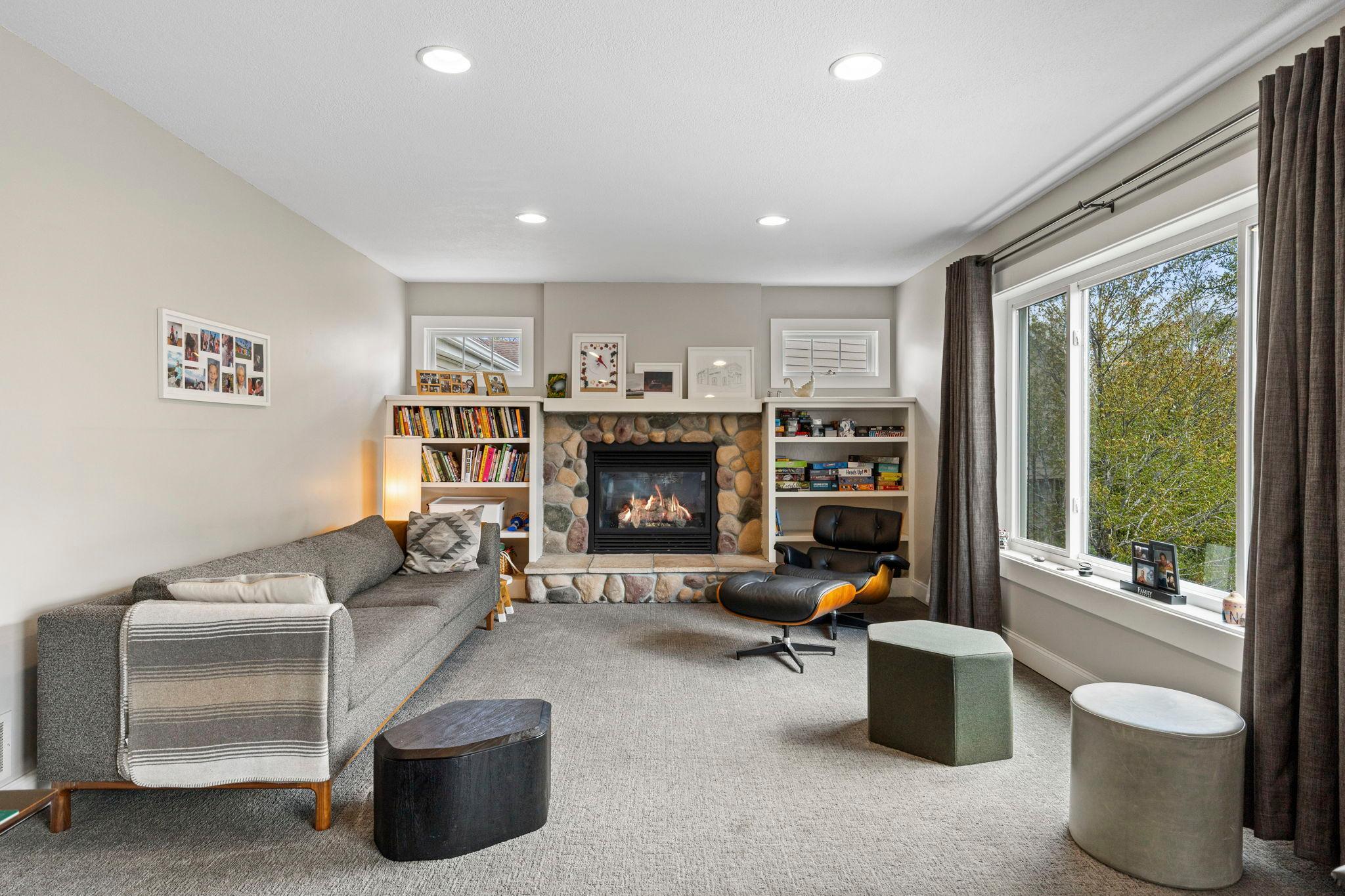 Family room with gas fireplace and large windows