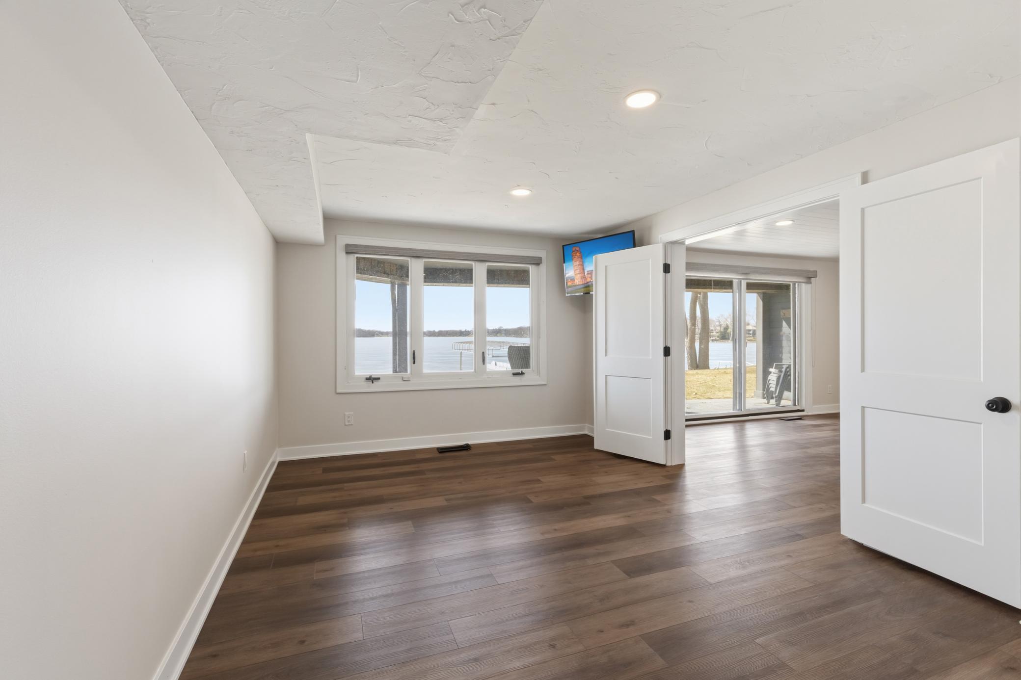 Bedroom 3 / Flex Space features French doors and windows offer stunning lake views!