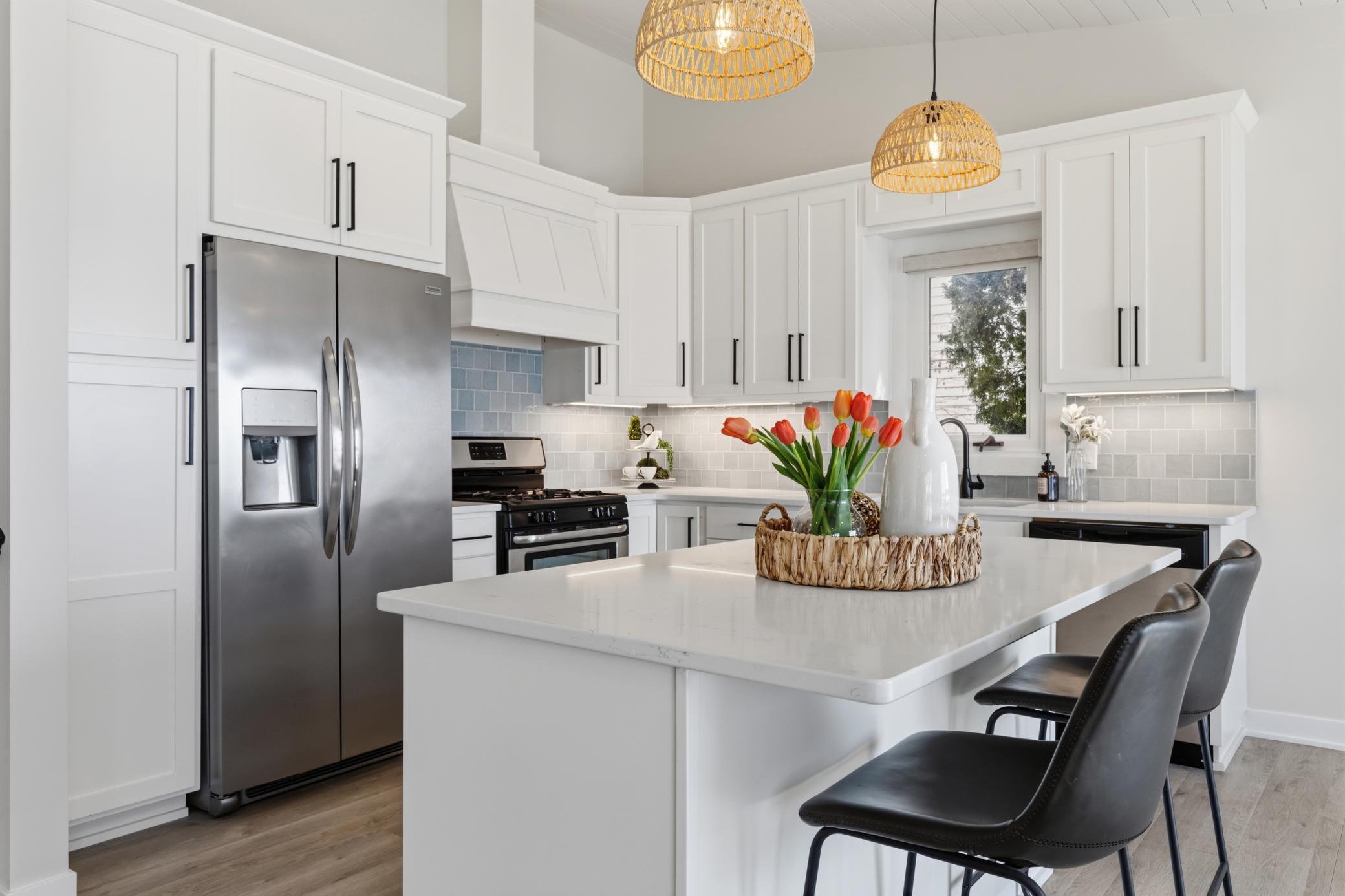 Kitchen was remodeled in 2024! Enameled cabinetry features flat panel doors, roll-out storage, under cabinet lighting, full height pantry and "Eat-in" center island.