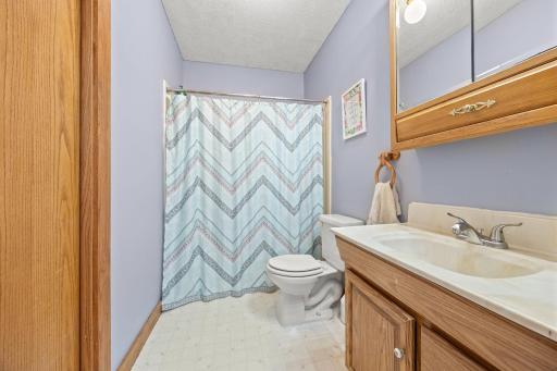 Primary Bedroom's full bathroom with walk in closet to left