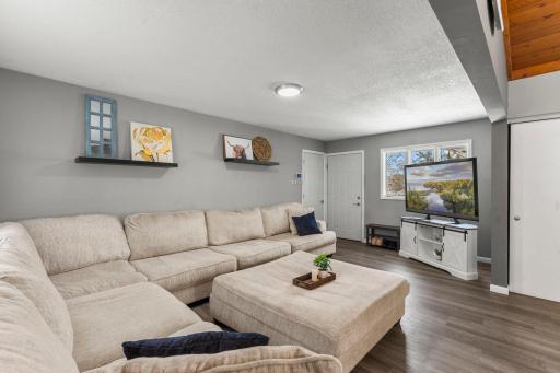 The main-level living room provides the perfect space for both relaxing and entertaining, with direct access to a large backyard deck and the attached two-car garage.