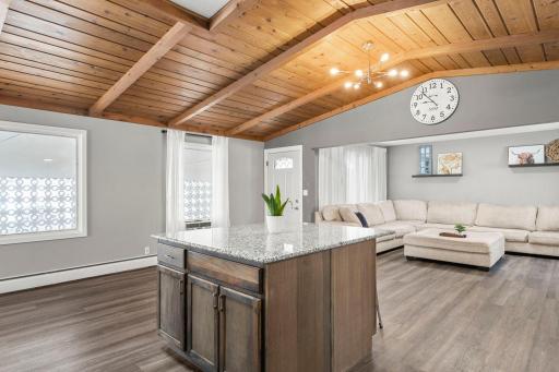 Another view of the open-concept floor plan from the kitchen, showcasing the adjacent living room.