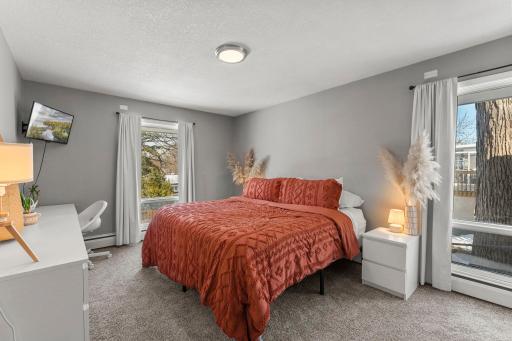 This level also includes three bedrooms, highlighted by a primary suite with brand-new carpeting, fresh paint, and a private ensuite full bathroom.