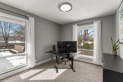 The bright and airy third bedroom on the main level, featuring new carpeting.