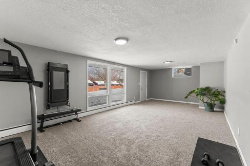 The finished lower level boasts new carpeting throughout and an expansive family room with windows overlooking the peaceful backyard, along with walkout access to a covered patio.