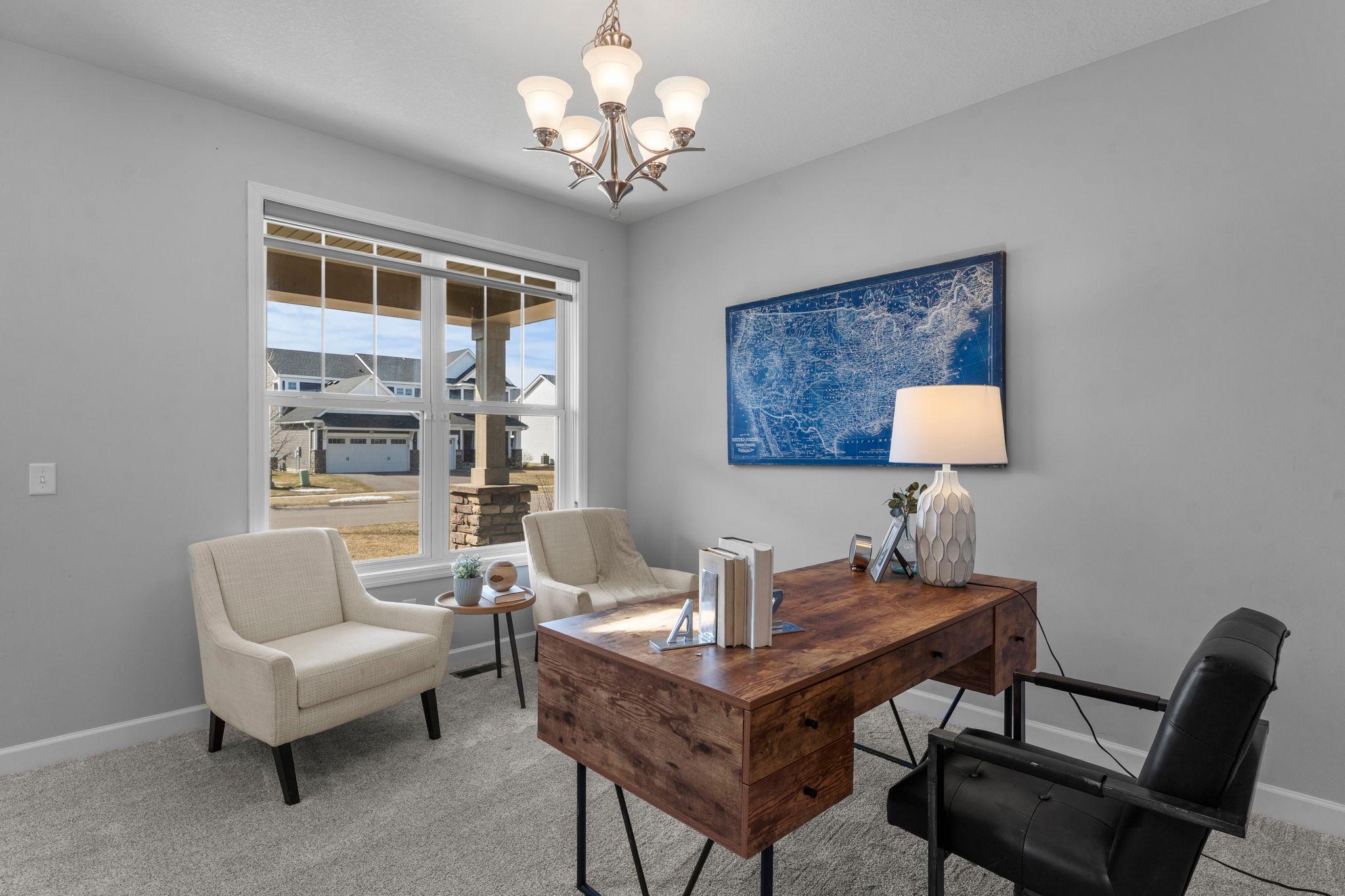 Also on the main level is a versatile flex room with new carpeting and a stylish light fixture, ideal for a formal dining room or home office.