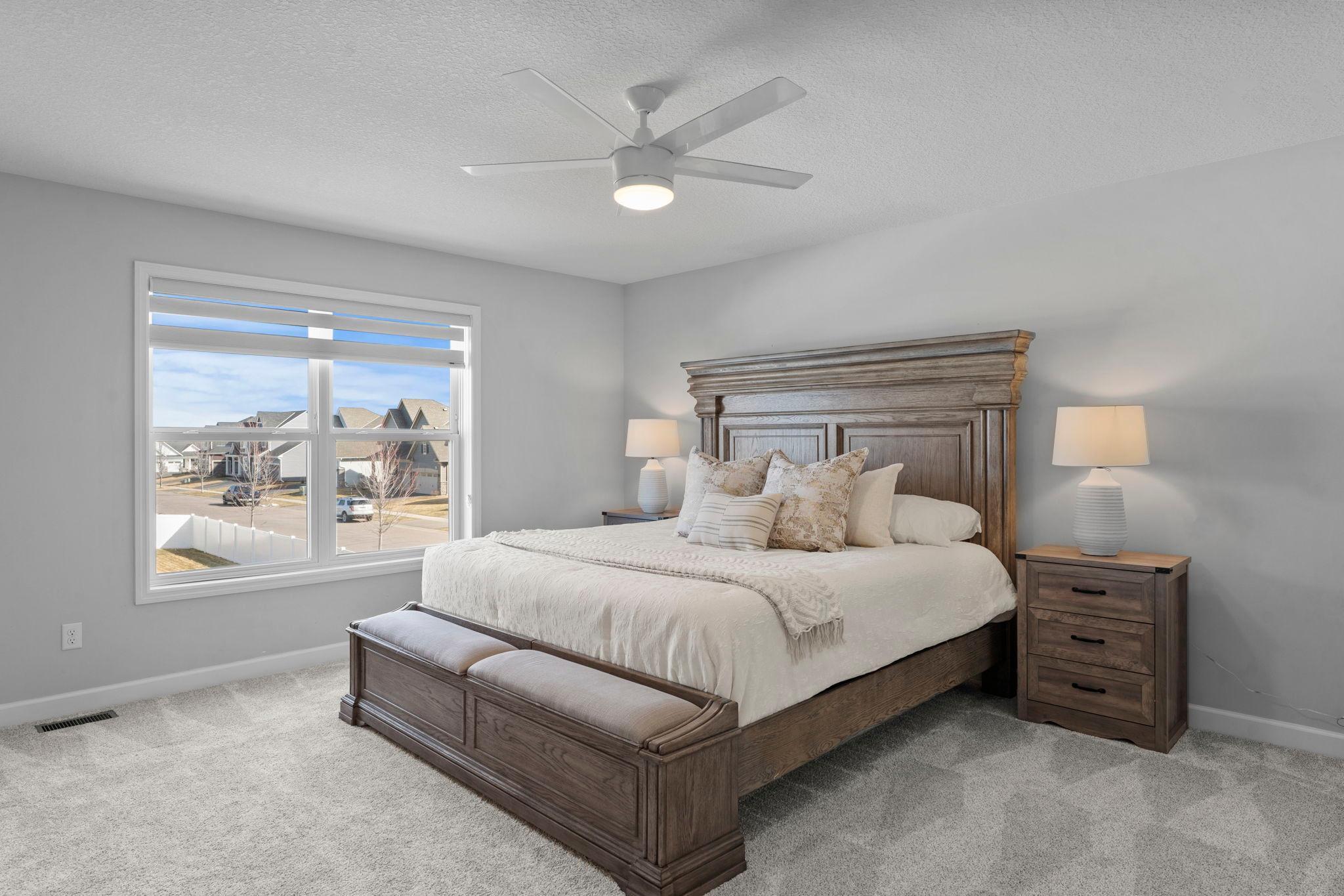 Upstairs offers four bedrooms, including a spacious primary suite with brand-new carpeting, a ceiling fan, and a large walk-in closet.