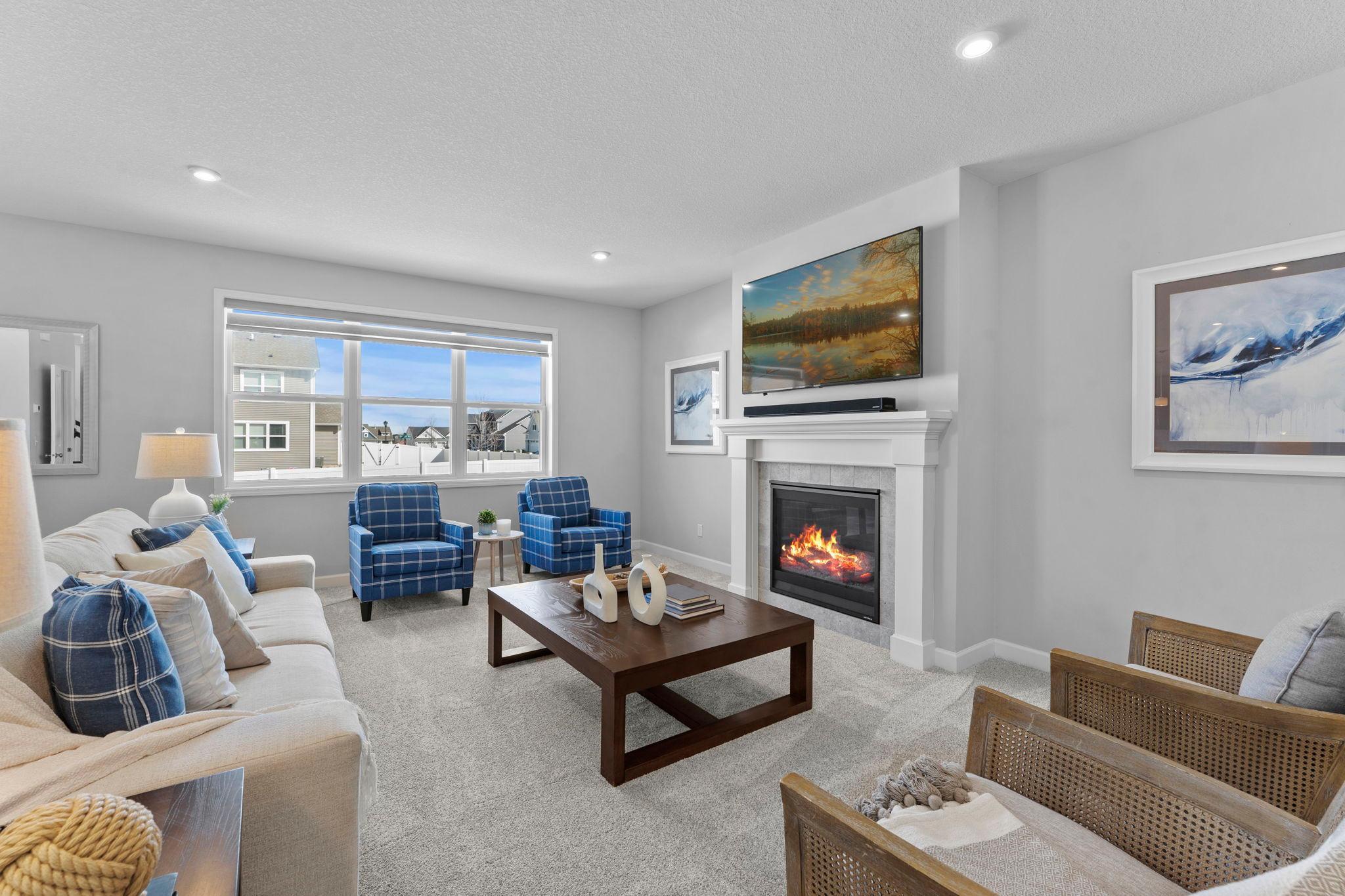 The main-level living room offers brand-new carpeting, a cozy gas fireplace with mantel, recessed lighting, and a large window overlooking the peaceful backyard.