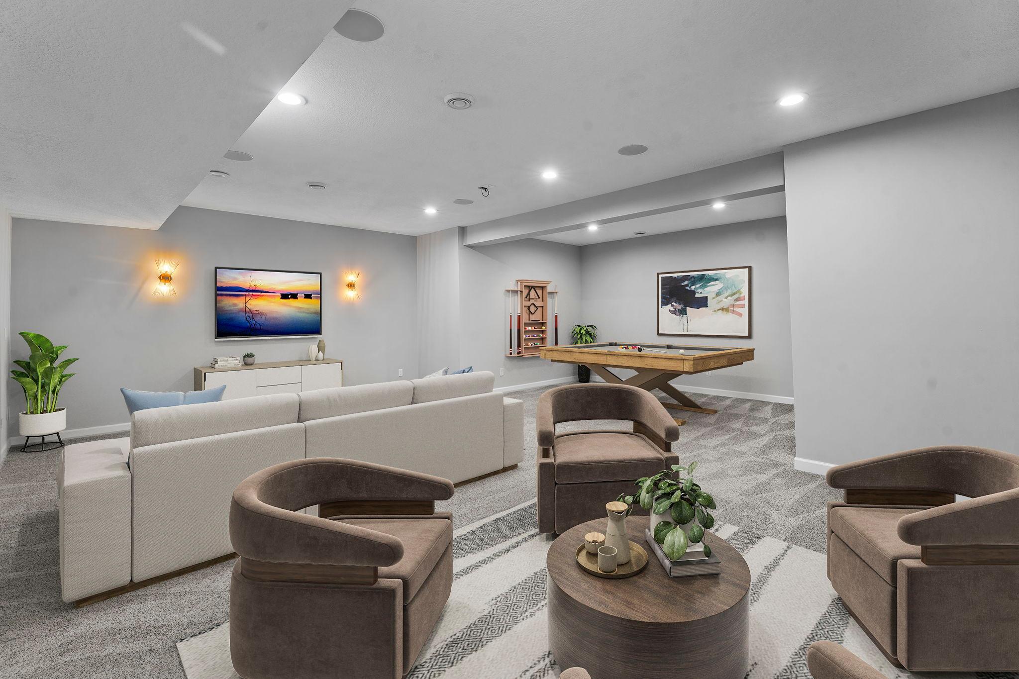 The newly finished lower level (2024) boasts fresh paint & new carpeting, along with an expansive family room pre-wired with installed speakers and designed for an 11.1 surround sound system—ideal for a home theater. (This photo is digitally staged)