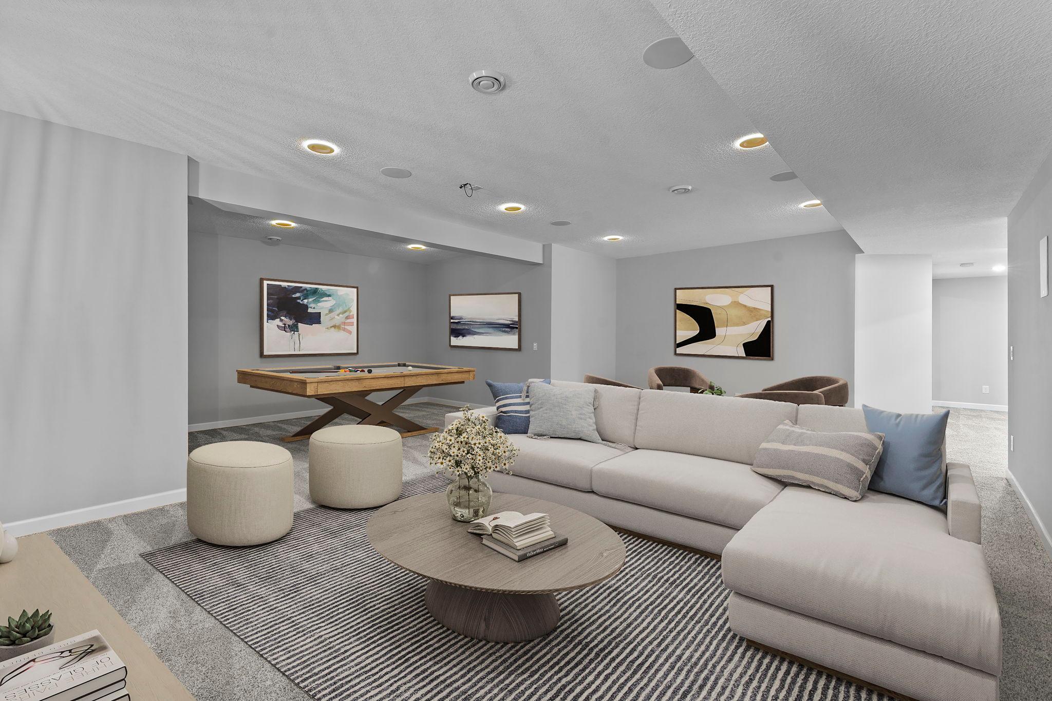 The family room features recessed ambient lighting (photo has been digitally staged).