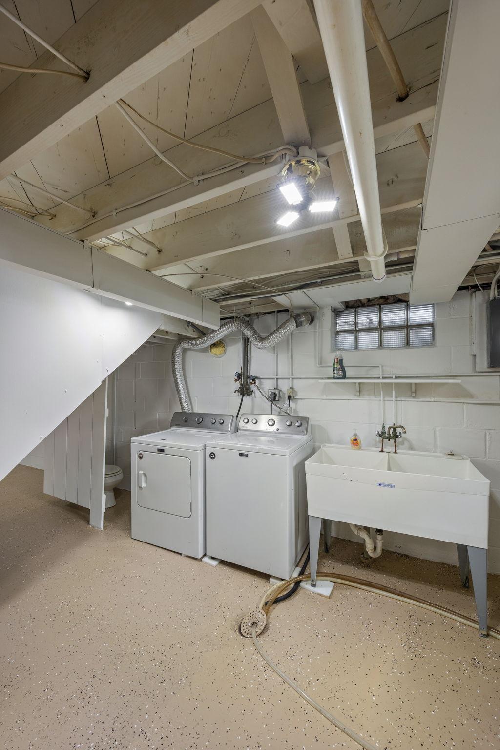 The lower level also includes the laundry area and a toilet, providing a great opportunity to add a future bathroom.