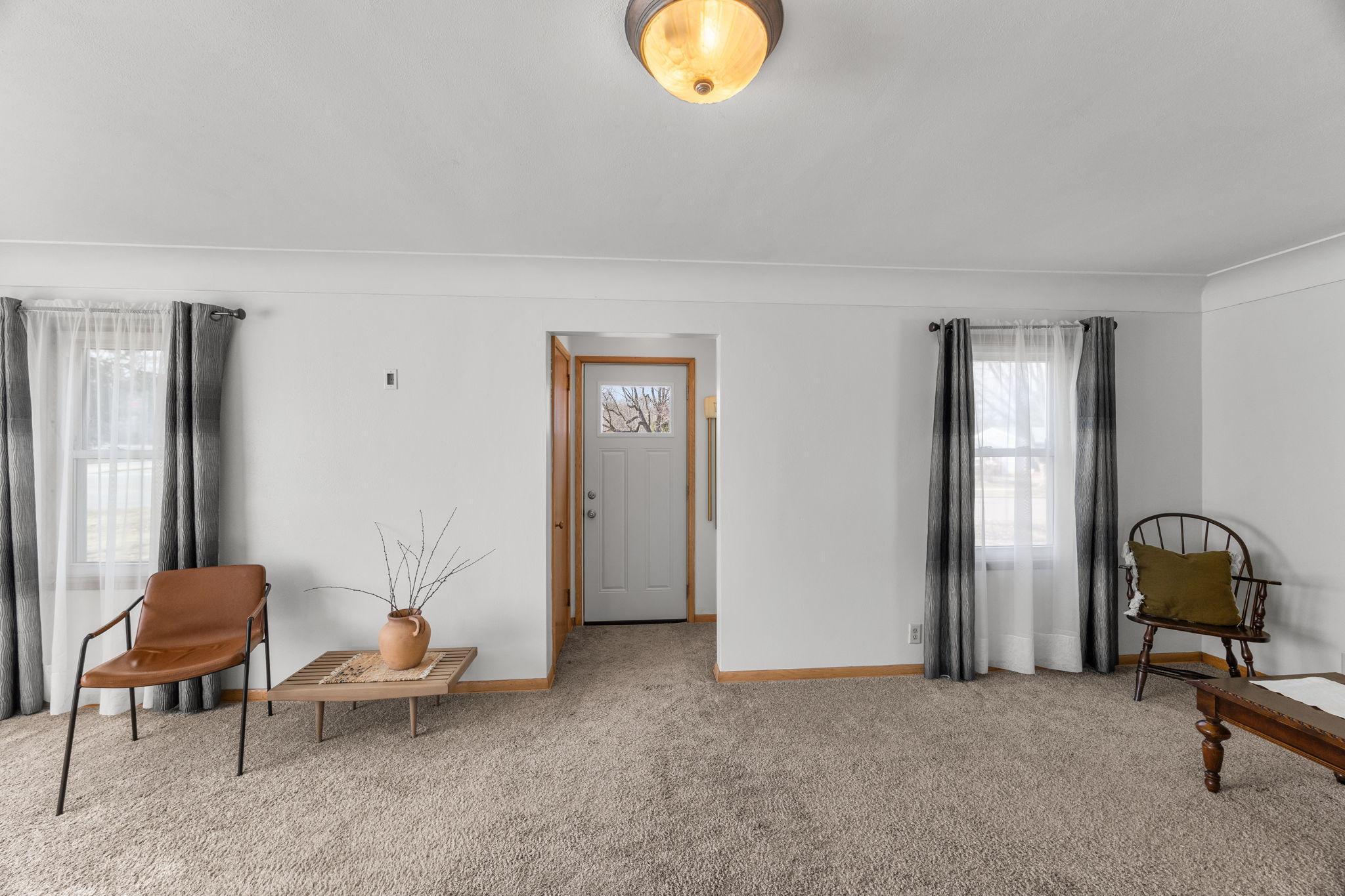 The front entrance is also easily accessible from the living room. Oak hardwood floors lie beneath the carpet in the living room, dining room, and bedrooms.