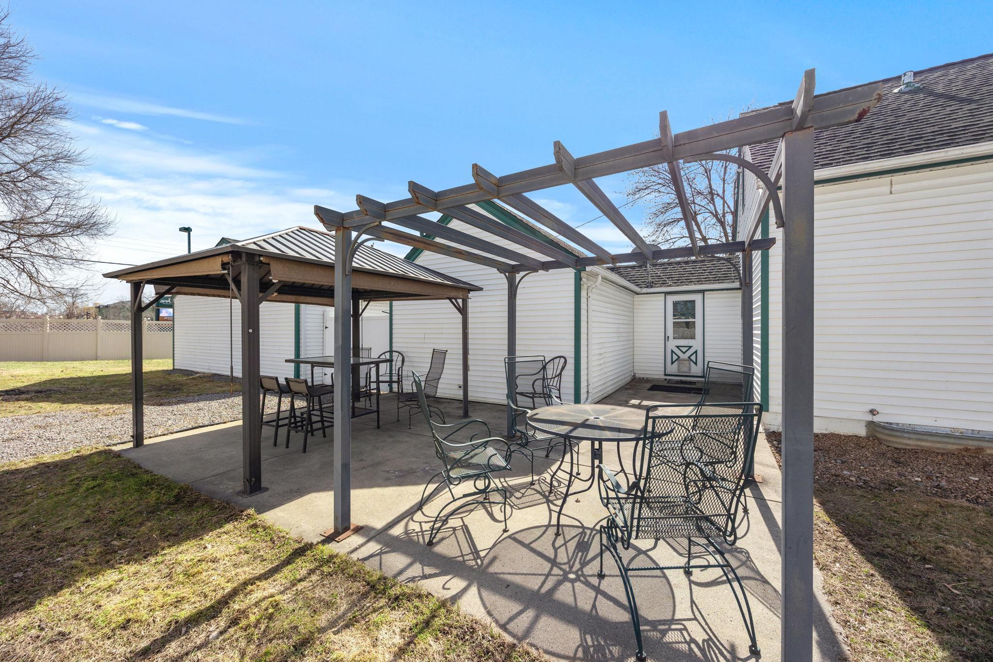 The expansive yard is perfect for relaxing or entertaining, featuring both a gazebo and a pergola.