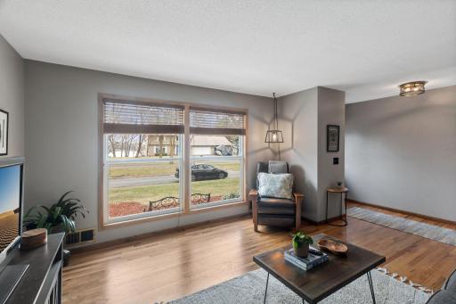 Step into the light-filled living room looking out to Rice Lake
