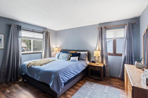 The primary bedroom offers views of Rice Lake
