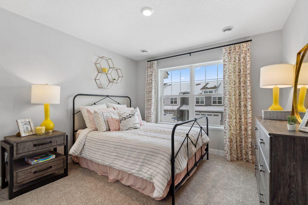 Both secondary bedrooms boast large windows. Photo of model home. Colors and options may vary.