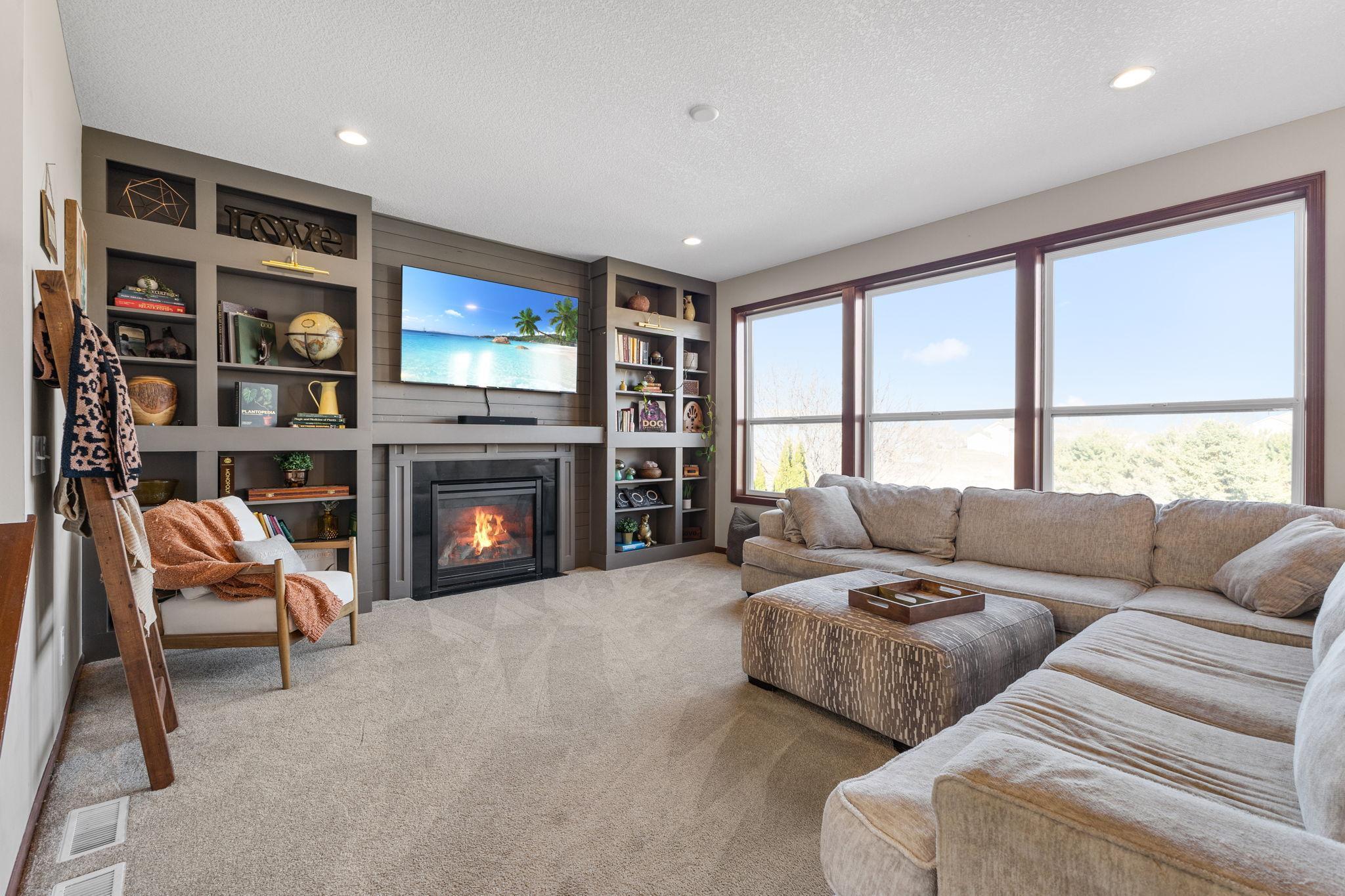 Living room with beautiful build in shelving and large picture windows