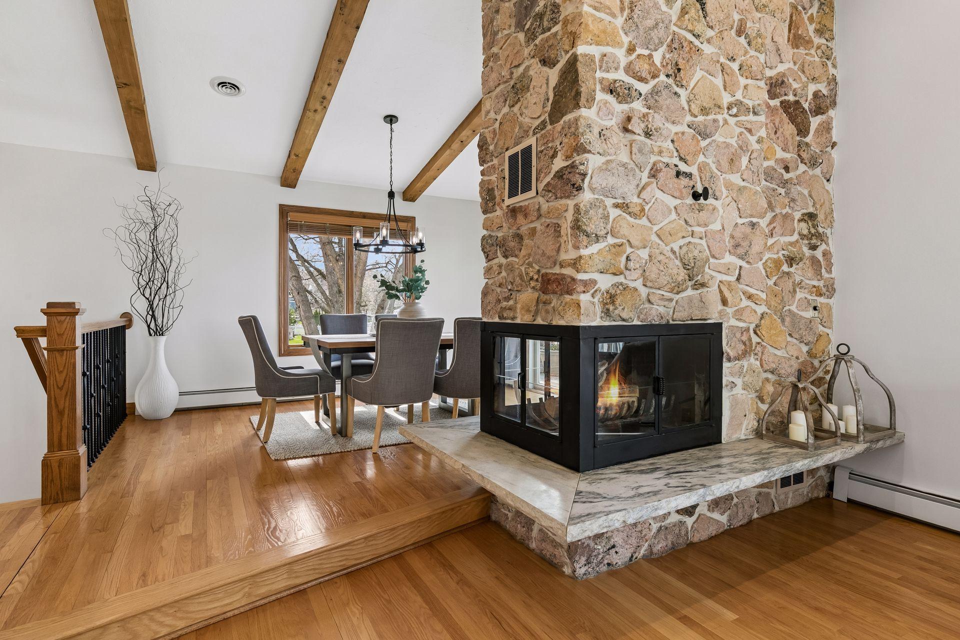 3 sided fireplace centers the kitchen, living area and dining room