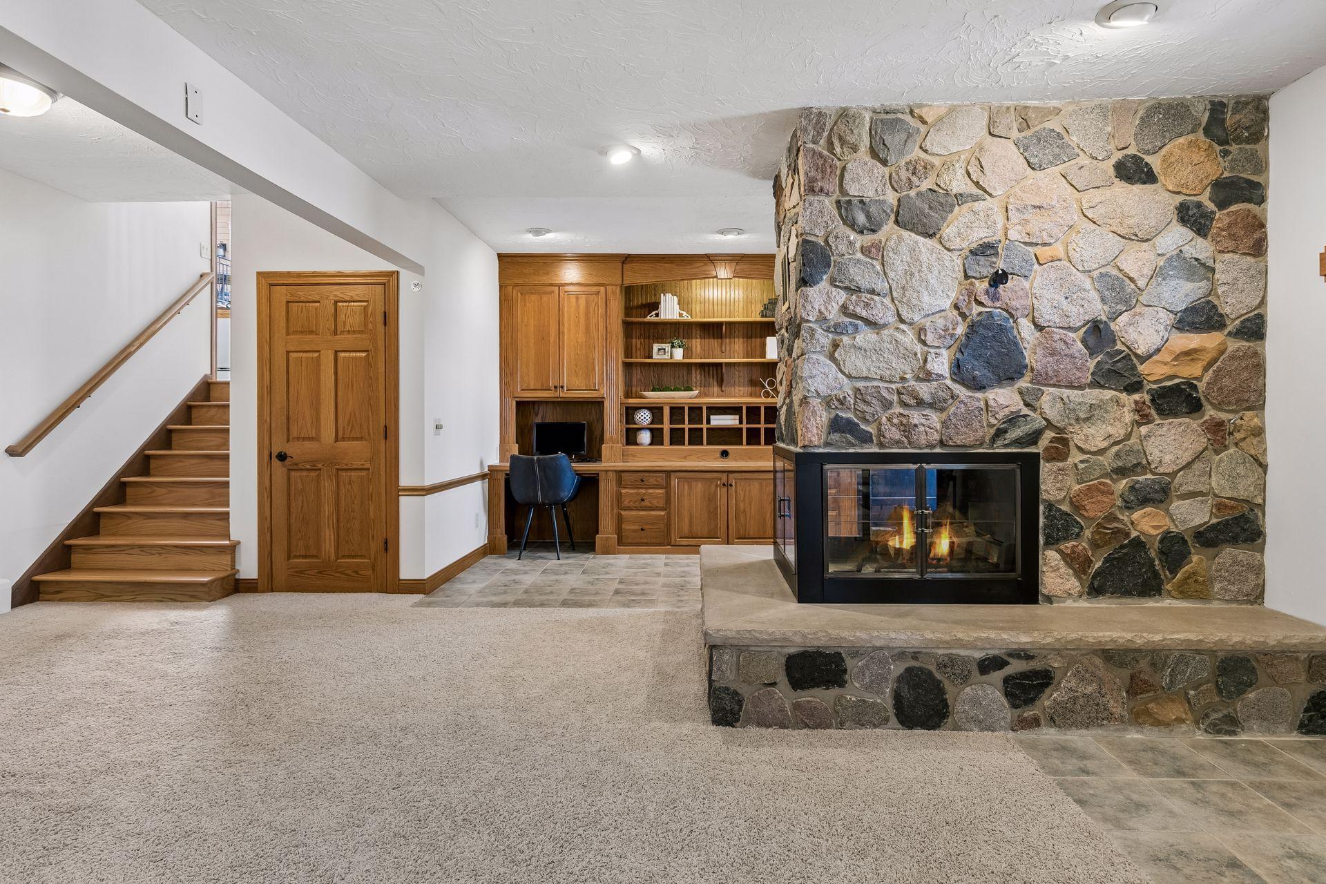 Beautiful stone fireplace also centers the lower level