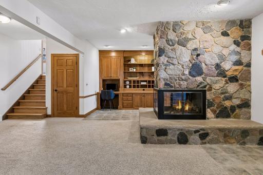 Beautiful stone fireplace also centers the lower level