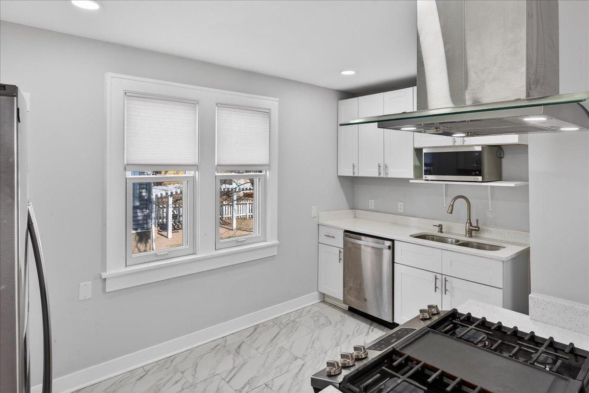 Kitchen windows letting in sun light all day long.