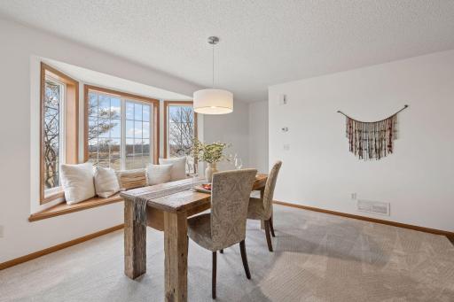 The bay window and window seat of this end-unit adds brightness to the dining area.