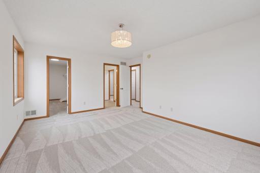 There are doors to the walk-in closet and upper-level bath off the primary bedroom.