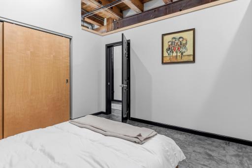Another view of the Primary bedroom space. Full wall closet system and privacy through enclosure.
