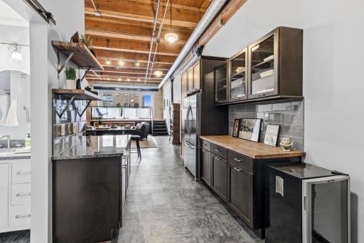 Newer, updated kitchen with an abundance of cabinetry. Custom Buffet, featuring glass cabinetry and butcher block countertop.