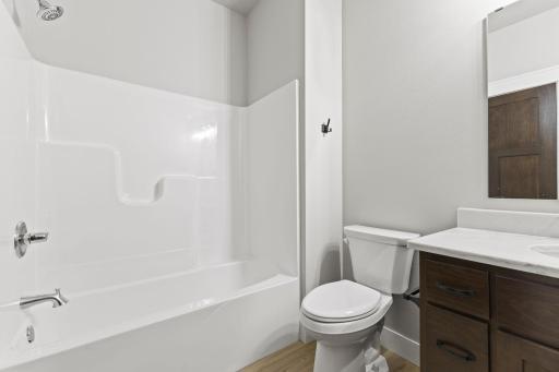 Full bathroom features a sleek tub/shower combo.